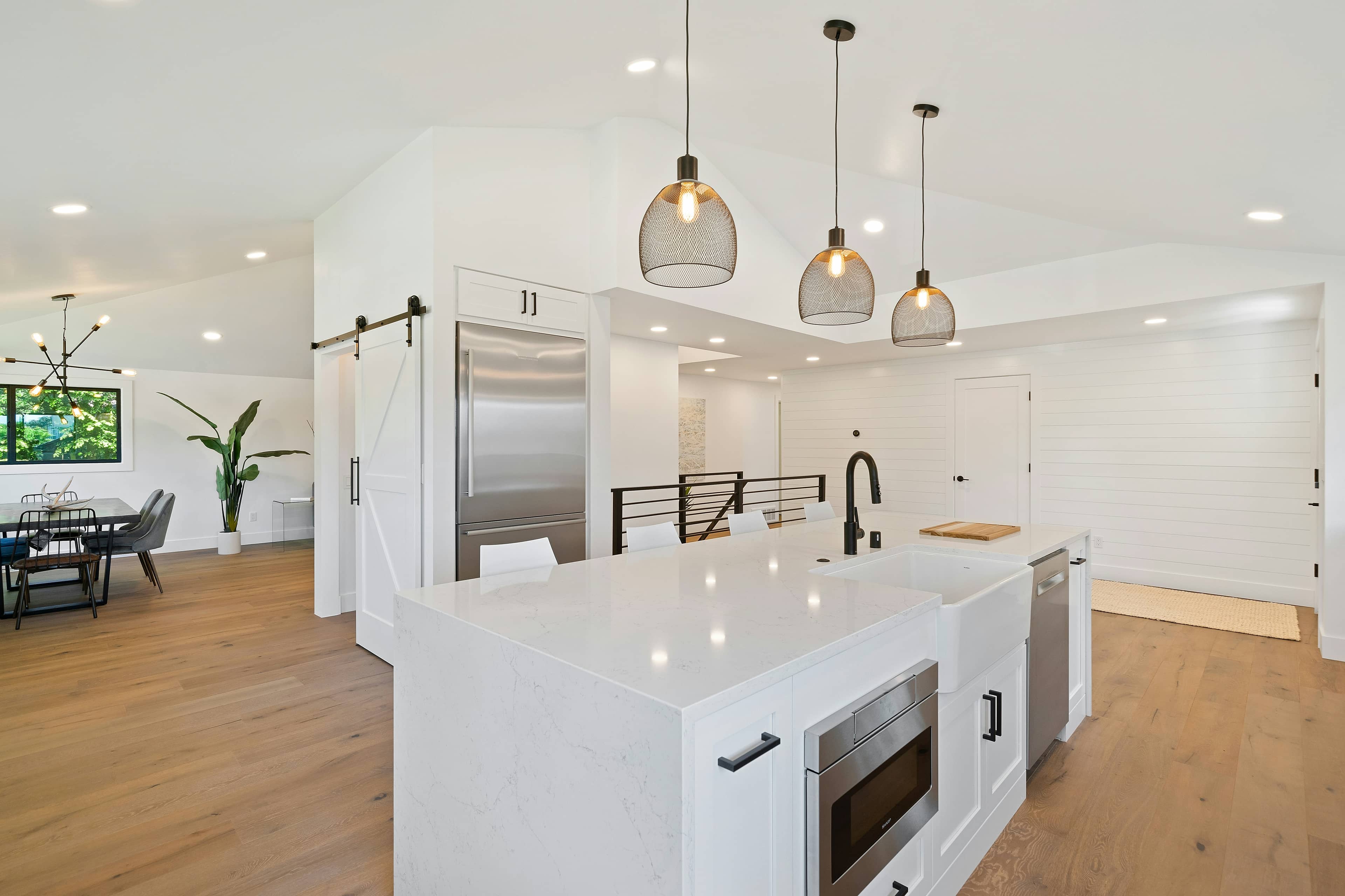 Modern custom kitchen with white cabinetry and quartz island installed in a Malaysian home
