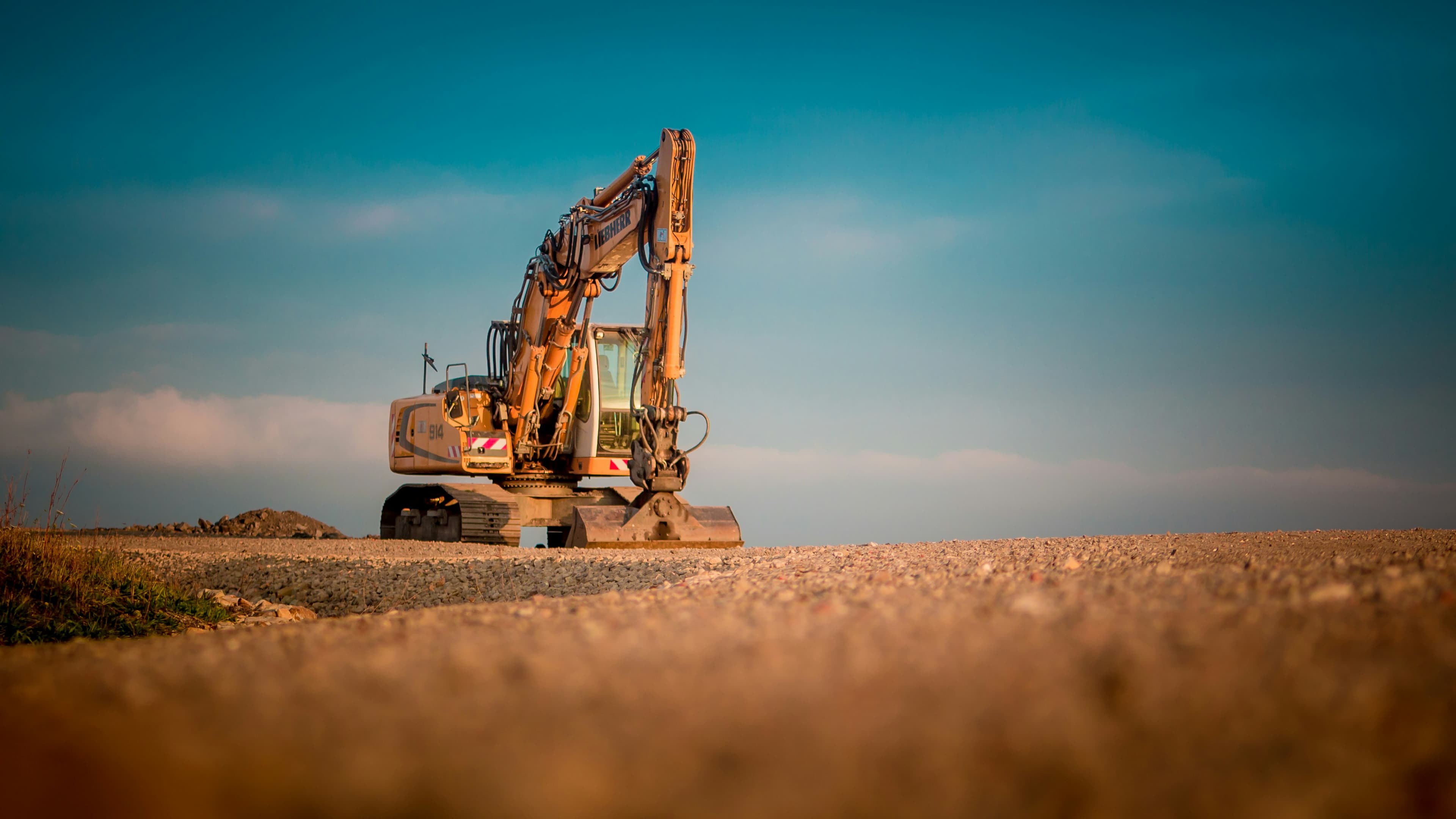 Outdoor construction equipment working under open sky, representing weatherproof awning installation