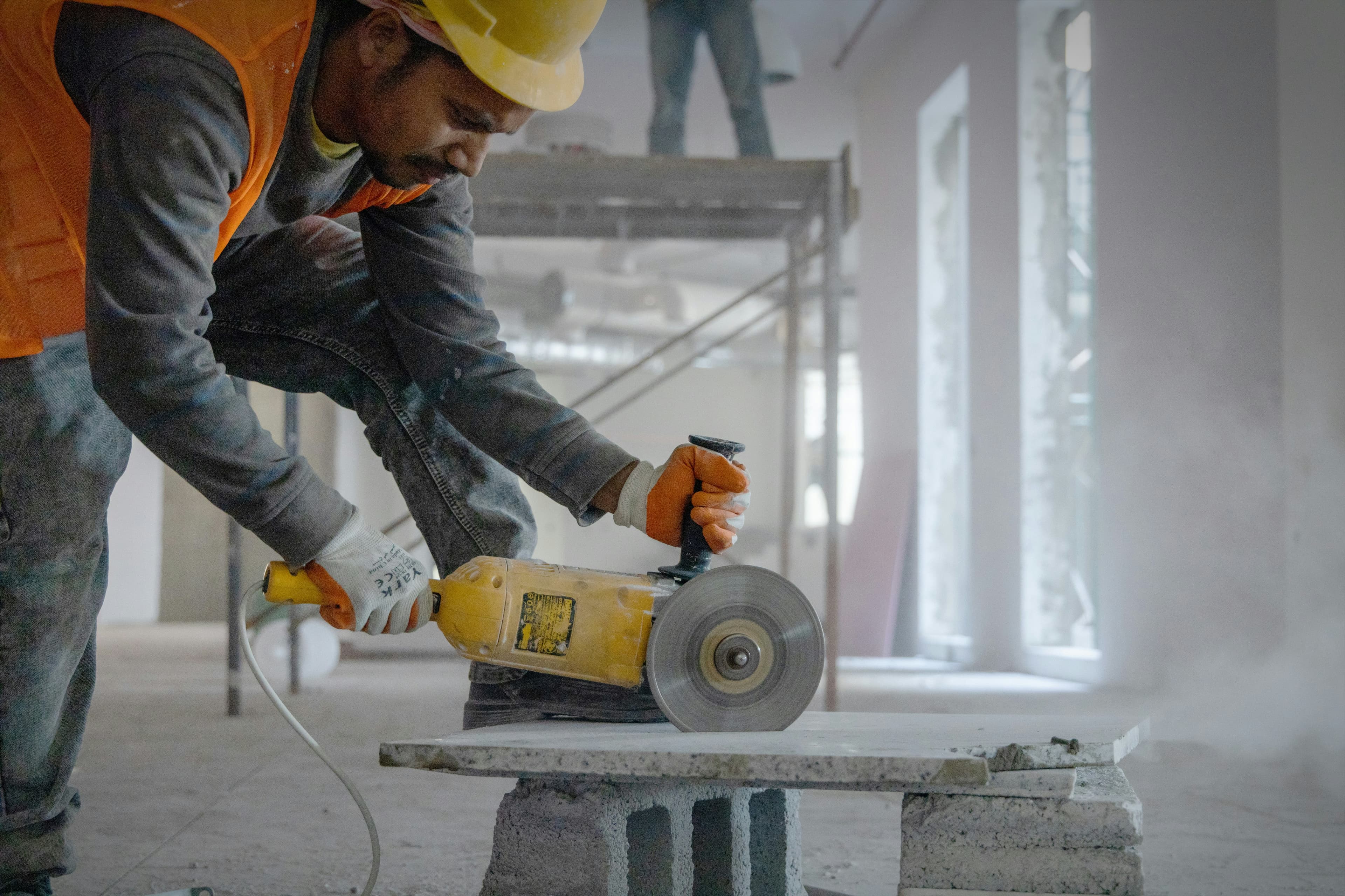 Welder grinding a metal joint during a custom fabrication job