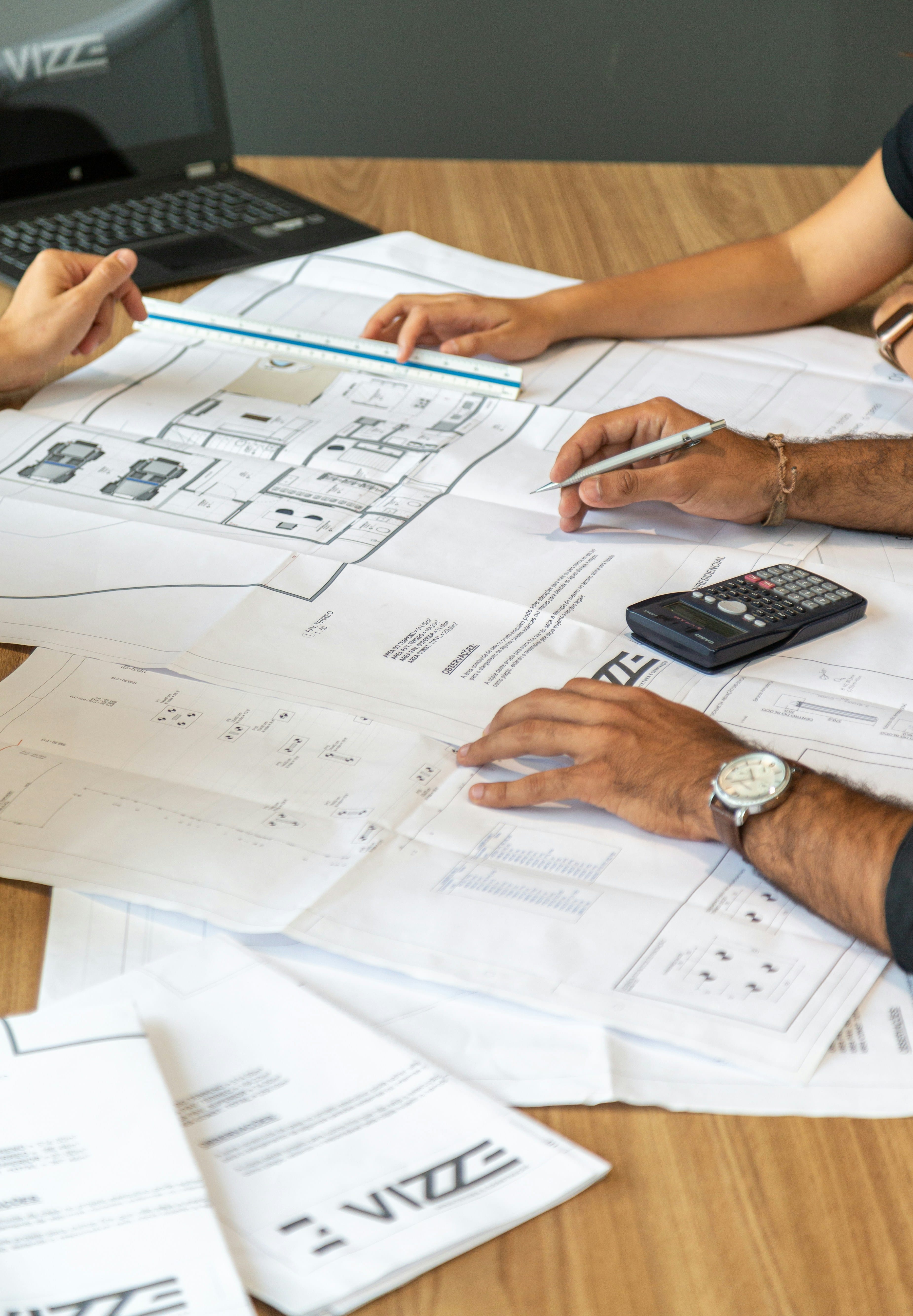 Homeowner reviewing a renovation quotation and plans with a contractor in Malaysia