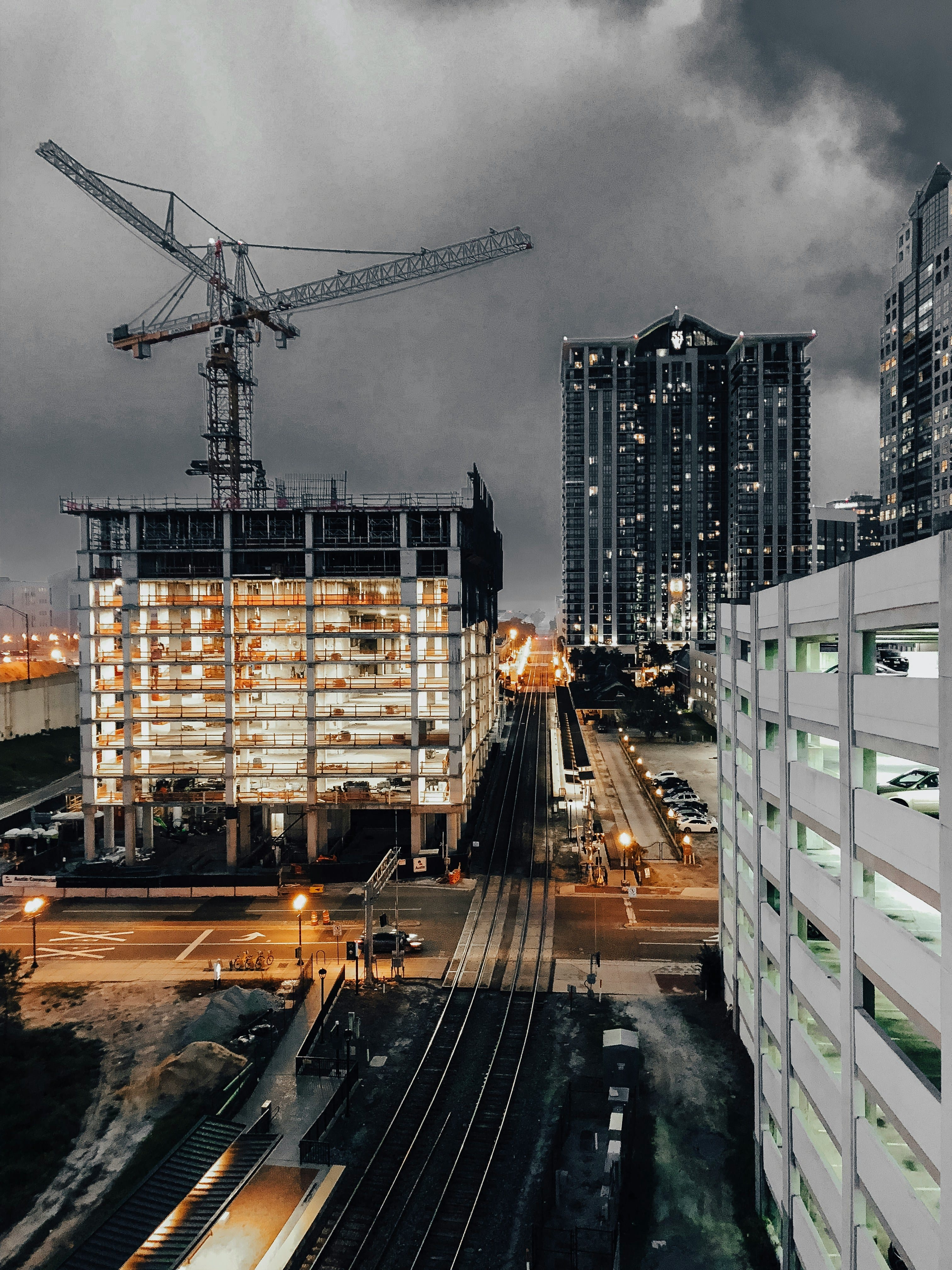 Civil infrastructure construction site with a tower crane, representing large-scale drainage and sewerage works