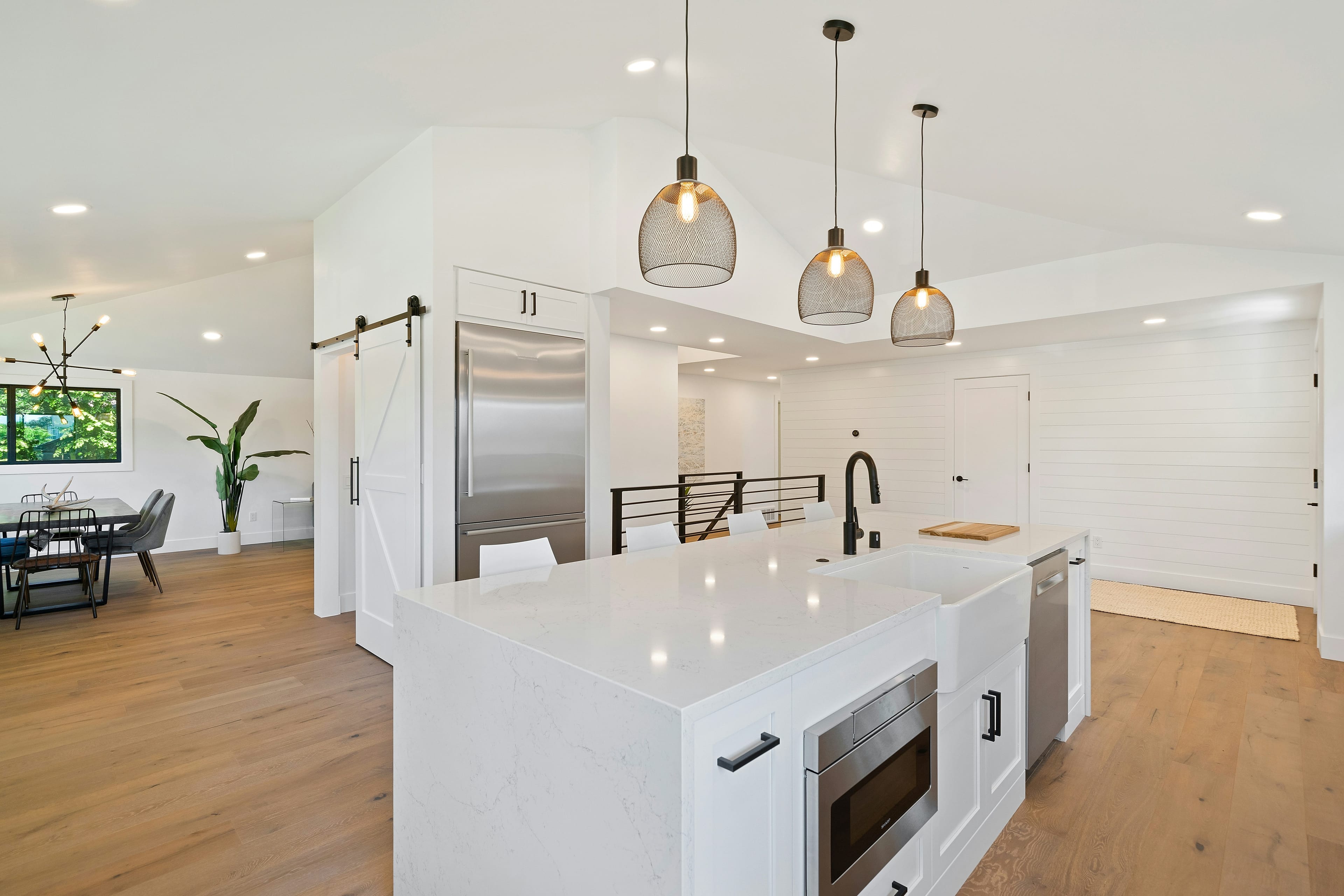 Modern custom kitchen with white cabinetry and quartz island installed in a Malaysian home